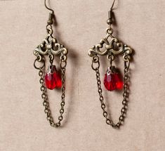 These striking earrings are made from tear drop shaped crystals, set in an ornate antique bronze filigree and embellished with delicate bronze chains. Available in black, red and amethyst. They will make a beautiful accessory for someone who loves the Gothic Victorian aesthetic. -The earrings are 2.5 inches long, without the french hook closure and almost an inch wide at the widest part of the filigree -They have a French wire for closure (nickel free) -Available in 3 colors: Black, Amethyst and Ornate Brass Dangle Chandelier Earrings, Ornate Brass Chandelier Dangle Earrings, Antique Metal Chandelier Dangle Earrings, Vintage Teardrop Brass Chandelier Earrings, Vintage Teardrop Chandelier Earrings In Brass, Vintage Brass Teardrop Chandelier Earrings, Victorian Dangle Chandelier Earrings In Brass, Victorian Brass Dangle Chandelier Earrings, Gothic Victorian Aesthetic