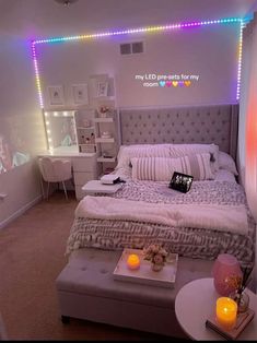 a bed room with a neatly made bed and lights