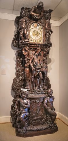 an intricately carved clock in the corner of a room