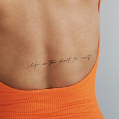 the back of a woman's upper body with an inscription on it