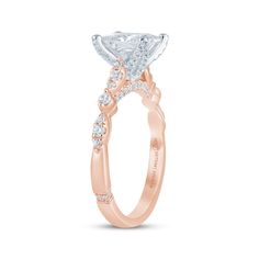 a rose gold engagement ring with a princess cut diamond in the center and side stones