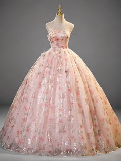 a pink dress with flowers on it is displayed in front of a mannequin