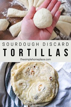 a hand holding a tortilla on top of a wooden table next to dough