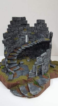 a miniature model of a stone structure with stairs