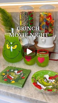 the grinch movie night is set up with plates, cups and mugs on the counter