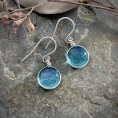 "Medium Size Blue Raindrop Earrings, Boho Silver Aesthetic Earrings, Simple Hippie Earrings, Light Blue Minimalist Nature Lover Gift, Best Friend Gift This collection is inspired by the beauty of rain and the rainbow of colors seen in nature. This is the perfect gift for anyone that loves nature, simplicity, and a customizable look! The sparkle is subtle and simple and changes depending on the lighting and the colors behind the glass. This wanderlust, boho, hippie style earrings are the perfect Minimalist Glass Earrings For Gift, Minimalist Glass Jewelry With Ear Wire, Minimalist Glass Drop Earrings, Hypoallergenic Round Glass Earrings, Minimalist Glass Dangle Earrings, Handmade Minimalist Round Earrings, Minimalist Wire Wrapped Round Earrings, Minimalist Blue Wire Wrapped Earrings, Hypoallergenic Turquoise Glass Earrings