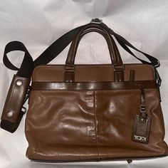 Tumi; Brown Leather Expandable Laptop Bag. Adjustable Shoulder Strap. All Zippers Work Nicely. Some Scuff And Scratches Throughout Bag, Such As Corners Of Bag And Surface As Shown In Photos. Normal Wear And Tear. Pre-Owned Condition. Tumi Bags, Laptop Bags, Laptop Bag, Brown Leather, Shoulder Strap, Laptop, Man Shop, Zipper, Leather