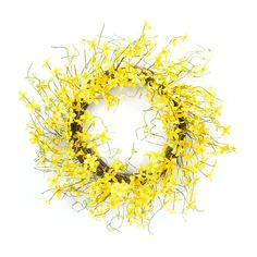 a wreath with yellow flowers is shown against a white background and looks like it has been made out of twigs