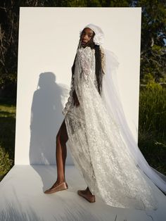 a woman in a white wedding dress and veil