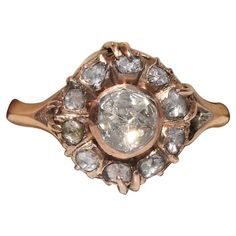 an old fashioned ring with diamonds in it's center, on a white background