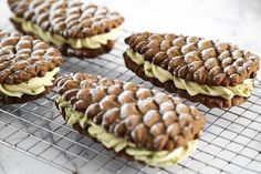 cookies with icing and powdered sugar are cooling on a wire rack