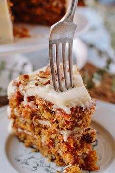 a piece of carrot cake on a plate with a fork