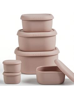 the stack of pink bowls has four lids on each side and one is empty in front