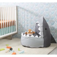 a child's bed with a stuffed shark in it