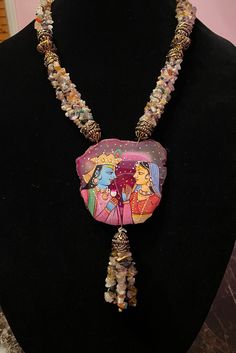 This is truly a one of a kind piece! This necklace is made from naturally occurring stones polished and finished to perfection! The  gorgeous pendant features a hand painted image of Radha Krishna with elegant earrings to match! For all of the Krishna lovers out there, this necklace is sure to bring blessings and bliss to its lucky wearer! Traditional Adjustable Hand Painted Necklace, Artistic Gold Hand Painted Necklace, Traditional Hand Painted Adjustable Necklace, Radha Krishna Jewellery Necklaces, Radha Krishna Gold Pendant, Natural Stone Necklace, Natural Stones Necklace, Gold Fashion Necklace, Painted Stone