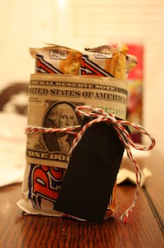 a bag filled with money sitting on top of a wooden table