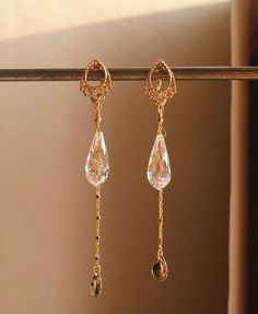 Aspen White Crystal Teardrop Dangle Earrings feature is an experiment in layer design. By adding one element at a time to gold filigree teardrop stud, each piece builds on the last, one by one. Featuring gold filigree teardrop studs, gold chains and a sparkly white crystal at the end. These earrings will frame your face as they extend downward from your ear. Make a bold and elegant statement with these beauties! ◊ 18K Gold Vermeil ◊ White Crystal ◊ This is a made to order piece. Please expect 3 Luxury Dainty Long Drop Jewelry, Elegant Gold Long Drop Chandelier Earrings, Elegant Gold Dangle Crystal Earrings, Gold Long Drop Chandelier Earrings For Formal Events, Elegant Long Drop Chandelier Earrings With Dangling Charms, Pierced Drop Earrings, Elegant Gold Drop Earrings For Pierced Ears, Gold Drop Jewelry For Pierced Ears, Rose Gold Teardrop Earrings