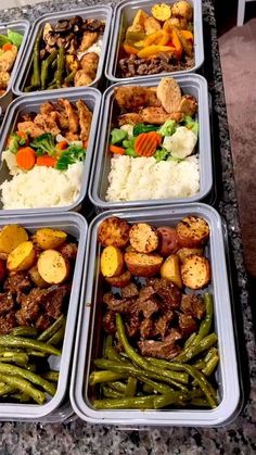 several trays filled with different types of food on top of a granite countertop