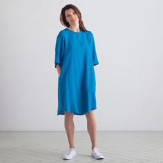 Swingy and sweet, the Luisa linen dress brings a new silhouette to a classic style. With a slightly asymmetric hem that is longer at the back, and gently bell-shaped half-length sleeves, this dress is bang up to date yet timelessly stylish. The simple, relaxed look is enhanced by two pockets at the front and a pleat detail on the back. We would appreciate if you choose your size carefully and help us minimize the returns. We might need 1 extra day on top of regular delivery timings to deliver th Relaxed Fit Linen Work Dress, Blue Linen Knee-length Dress With Relaxed Fit, Blue Knee-length Linen Dress With Relaxed Fit, Casual Linen Dresses For Workwear, Relaxed Fit Blue Linen Knee-length Dress, Relaxed Fit Linen Dress In Flax Color, Knee-length Flax Linen Dress, Relaxed Fit Linen Dress For Daywear, Linen Tunic Midi Dress For Daywear