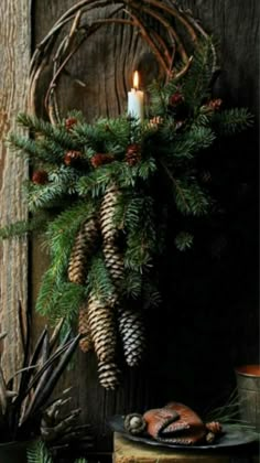 a wreath with pine cones hanging from it