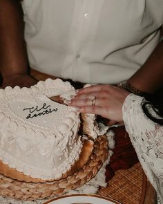 a close up of a person cutting a cake