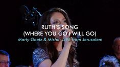 a woman holding her hand to her face while singing into a microphone with the words ruth's song where you go i will go