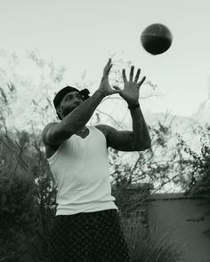 a man reaching up to catch a basketball