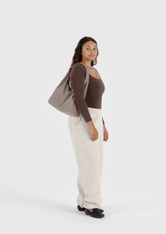 A slightly slouchy, slightly structured shoulder bag. Complete with an interior pocket so everything has a place. Fits up to a 13/14" laptop. 27.5" adjustable quilted strap Measures 10.5" × 14" × 4" Interior zip pocket. Recycled heavyweight nylon, recycled ripstop nylon lining Machine washable Everyday Beige Shoulder Bag With Soft Interior, Everyday Shoulder Bag With Soft Interior, Everyday Tote Shoulder Bag With Soft Interior, Everyday Bags With Double Handle And Soft Interior, Versatile Everyday Bag With Soft Interior, Versatile Bag With Soft Interior, On-the-go Tote Shoulder Bag With Soft Interior, Trendy Shoulder Bag With Soft Interior For Everyday, Versatile Bags With Soft Interior For Daily Use