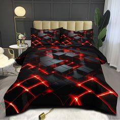 a bed covered in black and red comforters with glowing lights on the side of it