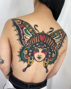 the back of a woman's body with tattoos on her upper and lower half