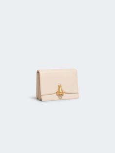 This shoulder bag is a luxurious accessory from the Schiaparelli brand, crafted in a beige hue. It is perfect for adding a touch of sophistication to any outfit. Small Leather Accessories, Tape Pattern, Beige Bag, Contemporary Luxury, Measuring Tape, Gold Ink, Hammered Silver, Leather Items, Leather Accessories