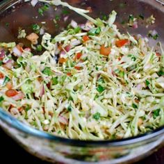 a glass bowl filled with coleslaw and carrots