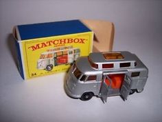 a small toy bus next to a matchbox box