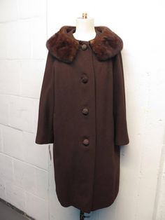 Up for sale is this stunning vintage 1950's cropped Mink fur collar wool swing coat. With distinct cord wrapped buttons. Silk lining has some minor wear. Sz M/L measurements below. Message with any additional questions. Don't forget to check out our other vintage items. Thanks for looking. measurements Bust  length Vintage Brown Outerwear With Faux Fur Trim, Brown Fur Coat With Buttons For Fall, Vintage Brown Wool Outerwear, Vintage Mink Outerwear With Faux Fur Trim, Brown Vintage Fur Coat With Faux Fur Trim, Brown Wool Fur Coat For Winter, Vintage Brown Long Wool Coat, Vintage Brown Wool Coat For Winter, Formal Vintage Outerwear With Faux Fur Trim