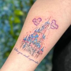 a person with a tattoo on their arm that has a castle in the sky and clouds