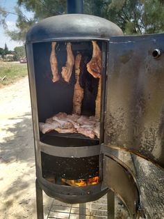 meat is being cooked on an outdoor grill