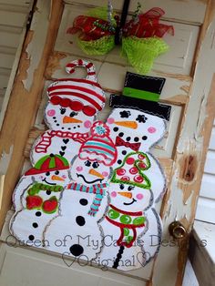 the snowman family door hanger is on display