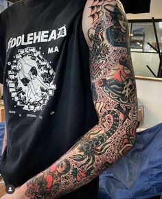 a man with many tattoos on his arm