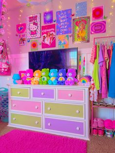 a bedroom decorated in pink, yellow and green with hello kitty pictures on the wall