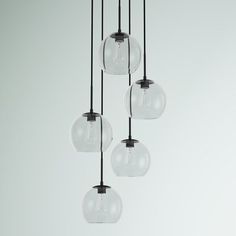 five clear glass globes hanging from a ceiling