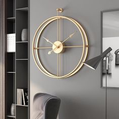 a large clock mounted to the side of a wall next to a book shelf and chair