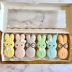 a box filled with cookies decorated like bunnies