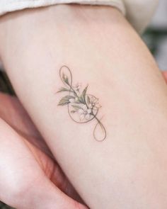 a woman's arm with a flower tattoo on the left side of her body