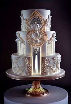 a white and gold wedding cake with intricate designs on it's tiered stand