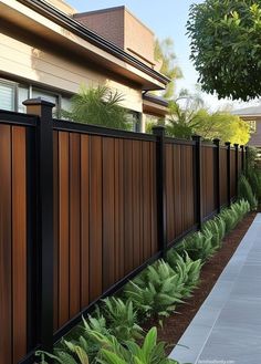 a long wooden fence next to a house