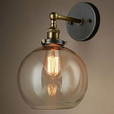 a light that is on the wall with a glass ball hanging from it's side