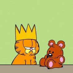 an orange bear sitting next to a brown teddy bear wearing a crown on top of their head