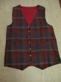 Classic handmade men's waistcoat, lightweight wool fabric with silver coloured buttons and little belt at back. Nice combination of blue, green, yellow & burgundy tones in this tartan. Two front pockets, pointed front & back and it is fully lined in contrast dark red satin.  I have hand washed it as wool and it came up lovely. Very good condition. Photographed with skirt & blouse to show proportions for women. Actual measurements : Chest 44 inches, shoulder to shoulder 15 inches, armhole depth a Fitted Plaid Vest For Winter, Fitted Plaid Cotton Vest, Mens Waistcoat, Men's Waistcoat, Tartan Men, Skirt Blouse, Mens Vests, Skirt And Blouse, Vest Outfits