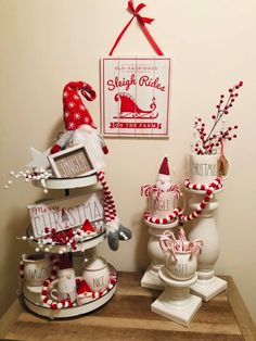 christmas decorations are displayed on a table in front of a sign that says santa's sleigh ride