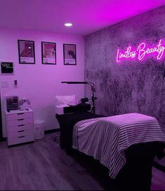 a bedroom with purple lighting and pictures on the wall